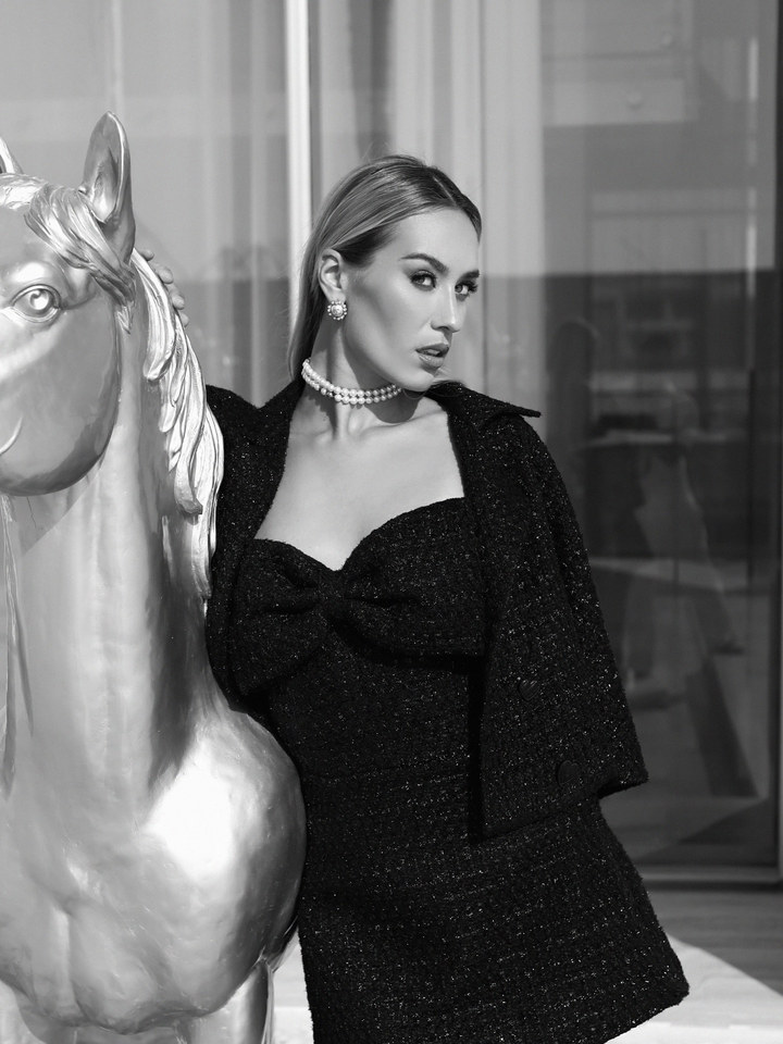Bespoke dressmaker Dubai — black tweed mini dress with bow shoulder, Haniye editorial